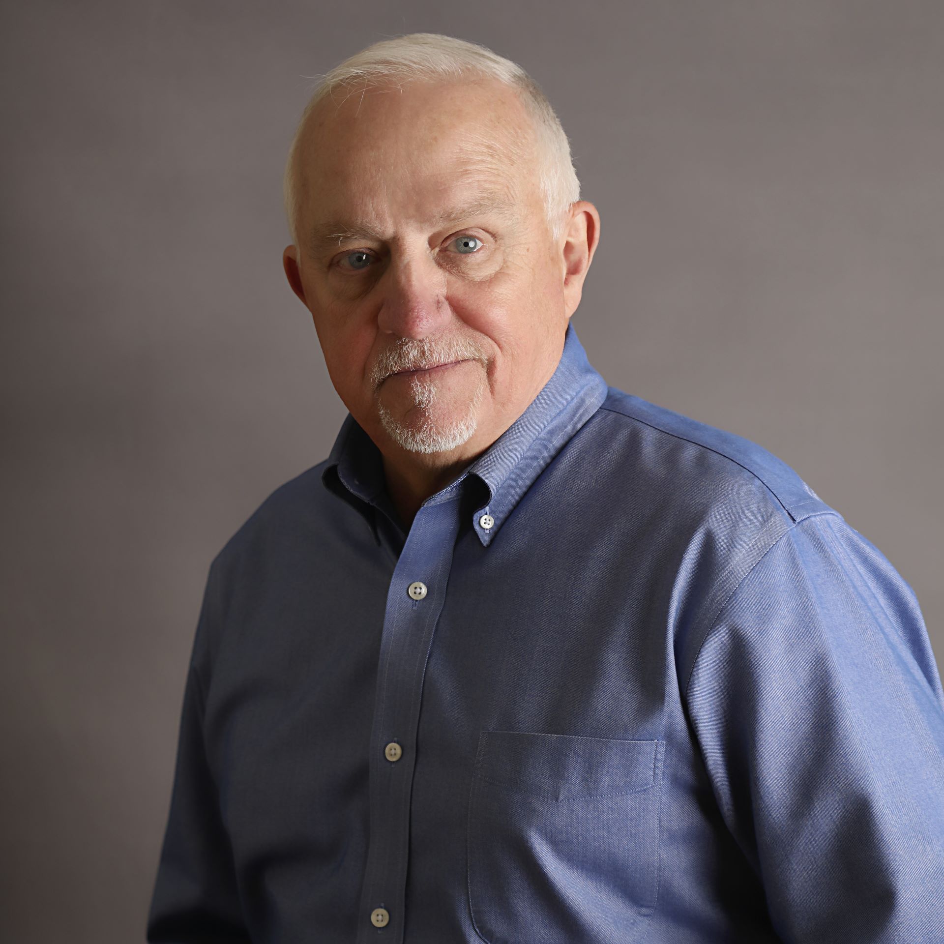 A man in a blue button-down shirt.