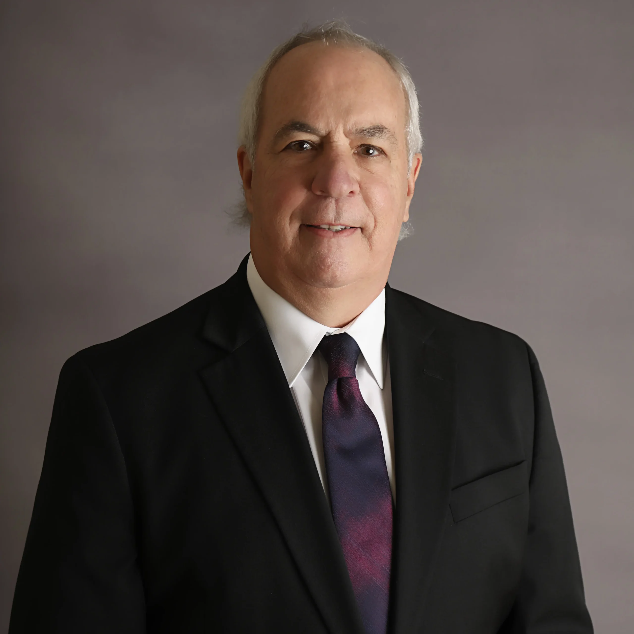 Man in suit with a purple tie.