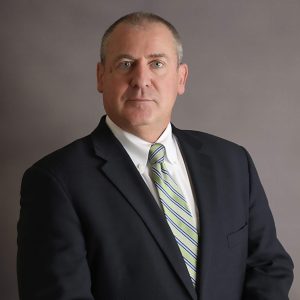 Man in a suit with a striped tie.